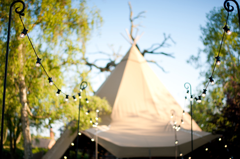 Professional colour photograph of wedding tipi in spring