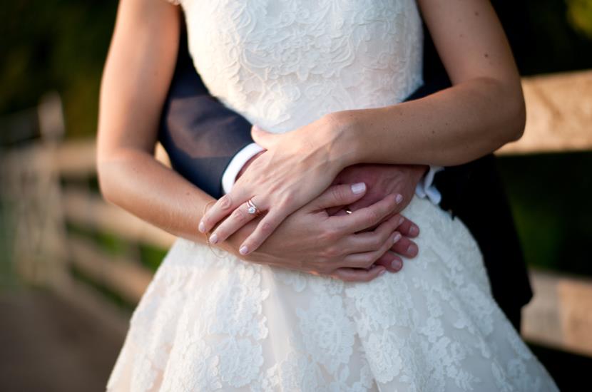 Professional colour photograph of a bride and groom holding each other